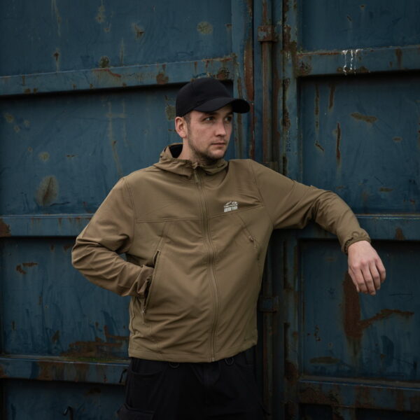 129875 TF 2215 Softshell Trail Jacket11 De TF-2215 Softshell Trail Jacket is een must-have voor iedereen met een actieve levensstijl en een liefde voor het buitenleven. Of je nu gaat wandelen, reizen, fietsen of gewoon geniet van de natuur, deze softshell jas biedt de perfecte combinatie van comfort, duurzaamheid en functionaliteit. Kenmerken: <ul> <li>Kwalitatieve SAB ritssluiting: De jas is voorzien van een hoogwaardige ritssluiting voor duurzaamheid en soepele werking.</li> <li>Capuchon met elastische sluiting: De verstelbare capuchon biedt bescherming tegen de elementen en kan strakker worden getrokken voor extra warmte en comfort.</li> <li>Elastische mouwsluitingen: Houd wind en regen buiten met elastische mouwsluitingen die perfect aansluiten op je polsen.</li> <li>Twee steekzakken met ritssluiting: Handige zakken om je handen warm te houden en om kleine benodigdheden veilig op te bergen.</li> <li>Verstelbaar koord aan de onderzijde: Pas de pasvorm van de jas aan naar wens en houd koude lucht buiten.</li> <li>Binnenzak: Een extra zak aan de binnenkant van de jas voor het veilig opbergen van waardevolle spullen.</li> <li>Gaatjes onder de oksel: Deze openingen zorgen voor ademend vermogen, zodat je comfortabel kunt blijven, zelfs tijdens intensieve activiteiten.</li> </ul> De ademende en waterdichte buitenlaag van de jas beschermt je tegen onverwachte weersomstandigheden en houdt je droog, zelfs in een regenbui. Het is de ideale metgezel voor buitenactiviteiten in alle seizoenen. Kortom, de TF-2215 Softshell Trail Jacket is ontworpen voor avonturiers die graag genieten van de schoonheid van de natuur, zonder concessies te doen aan comfort en bescherming. Kies voor kwaliteit en functionaliteit met deze softshell jas.